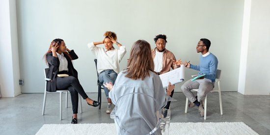 Diverse group of adults talking together during a group support session