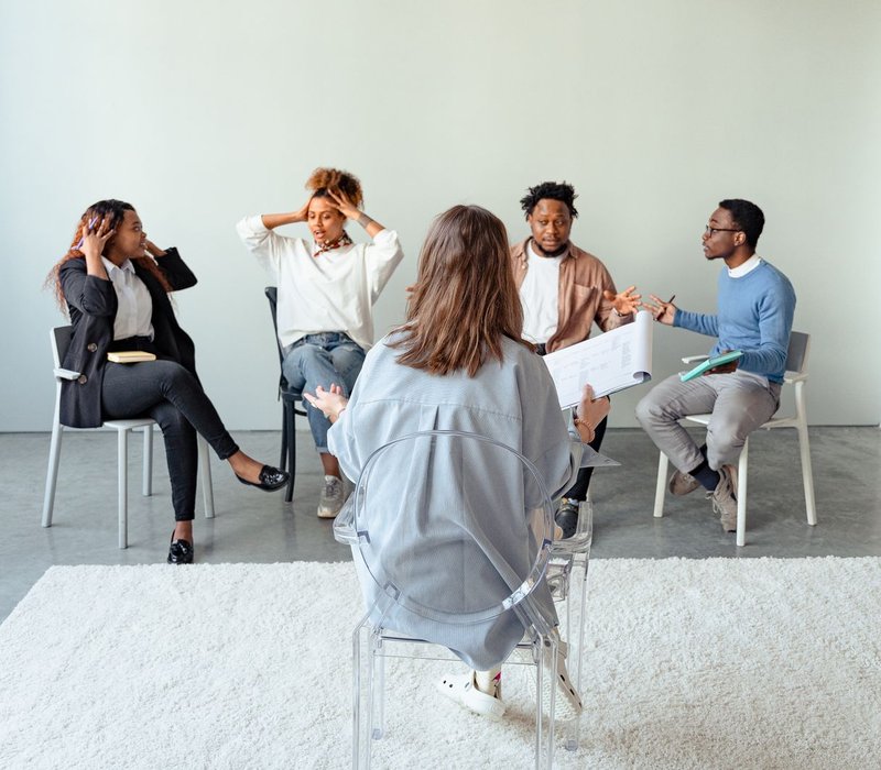 Diverse group of adults talking together during a group support session