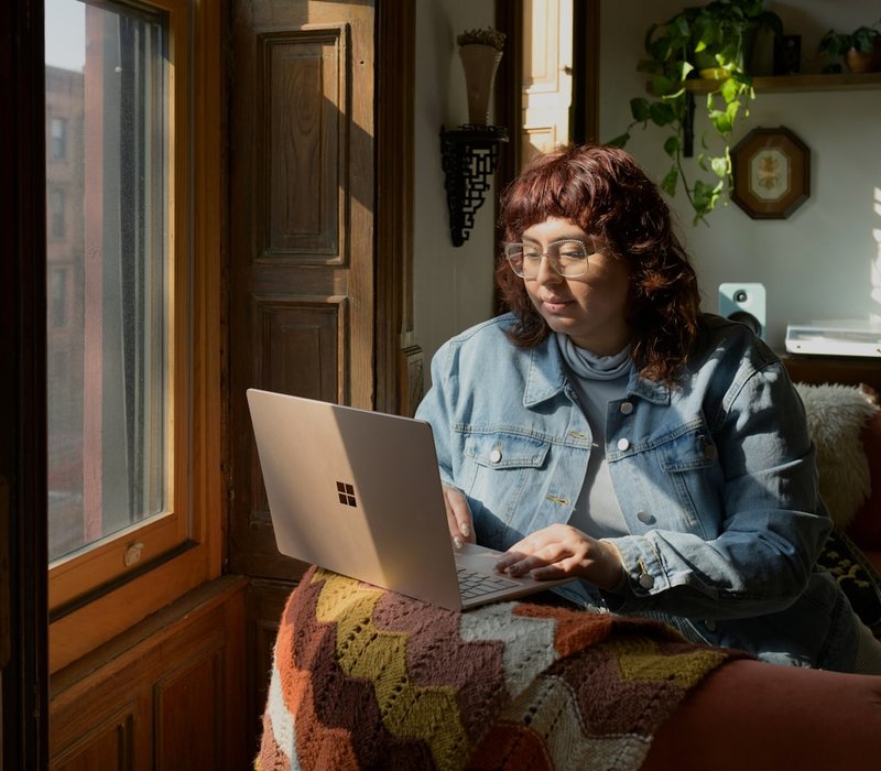 Woman attending a telehealth therapy session from her couch at home
